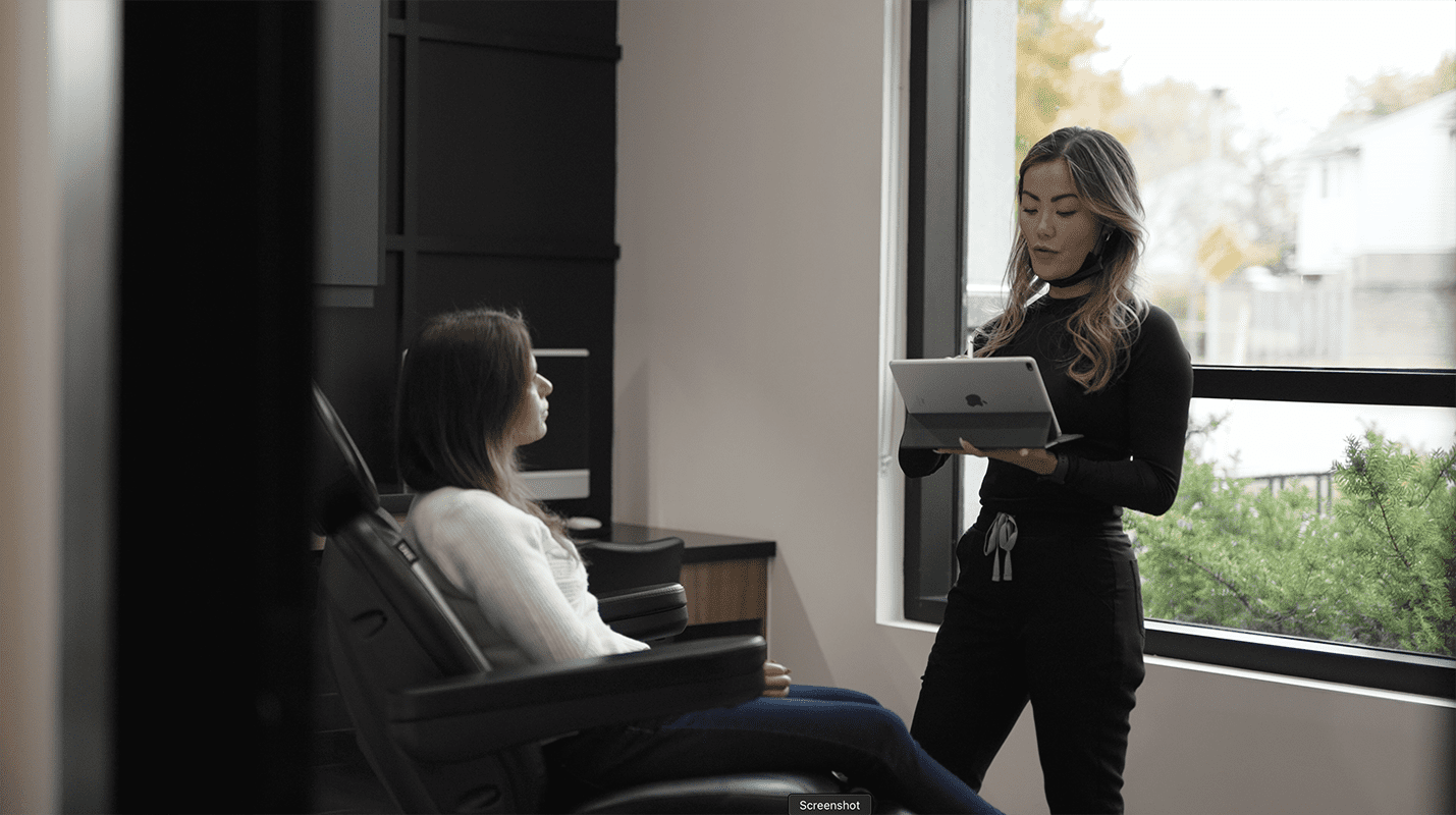 Nurse Practitioner Belita Savage consulting a patient about personalized facial and injectable treatments at Kontour Medical Aesthetics in London, Ontario.